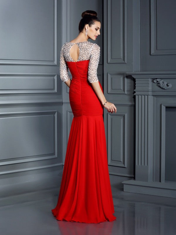Robe longue en mousseline de soie, manches 3/4, décolleté trompette/sirène, perles