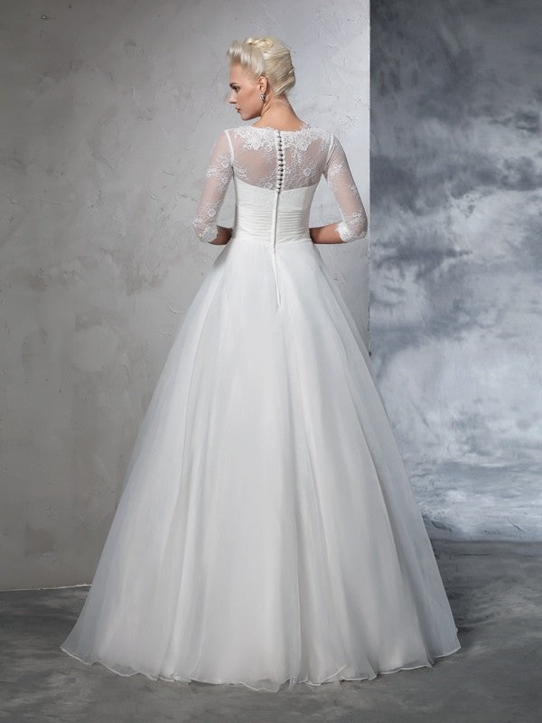 Robe de mariée longue en organza, manches 3/4, avec appliques et bijoux