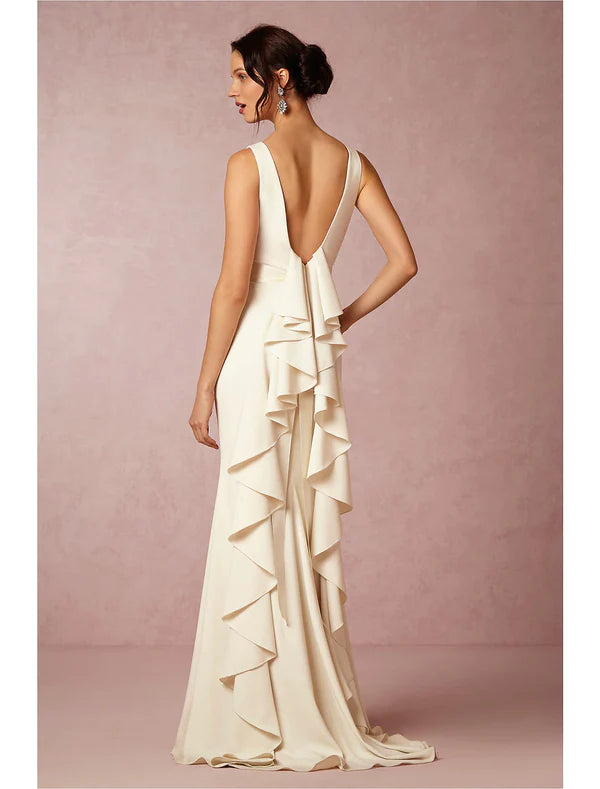 Back view of a casual open back sheath wedding dress with scoop neck and draping.
