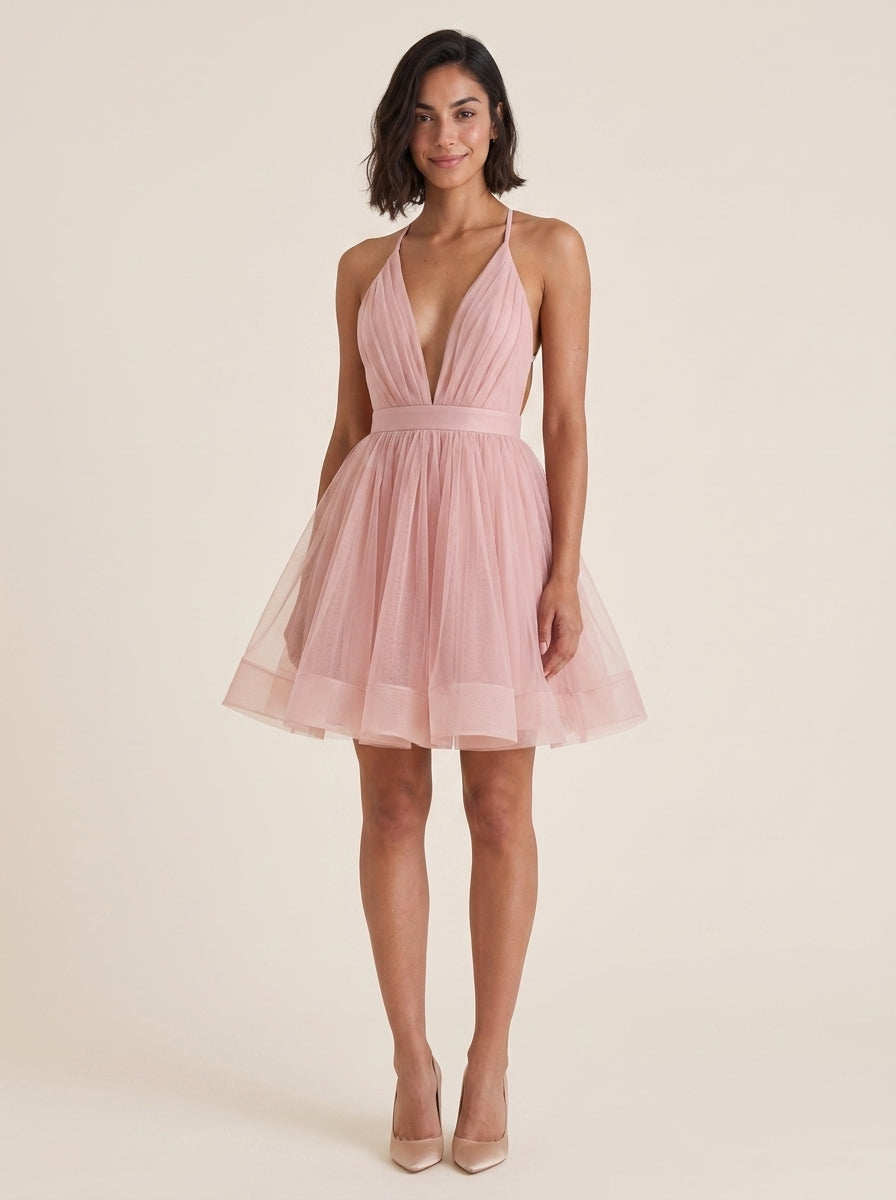Front detail of the blush A-line dress, highlighting the deep V-neckline.