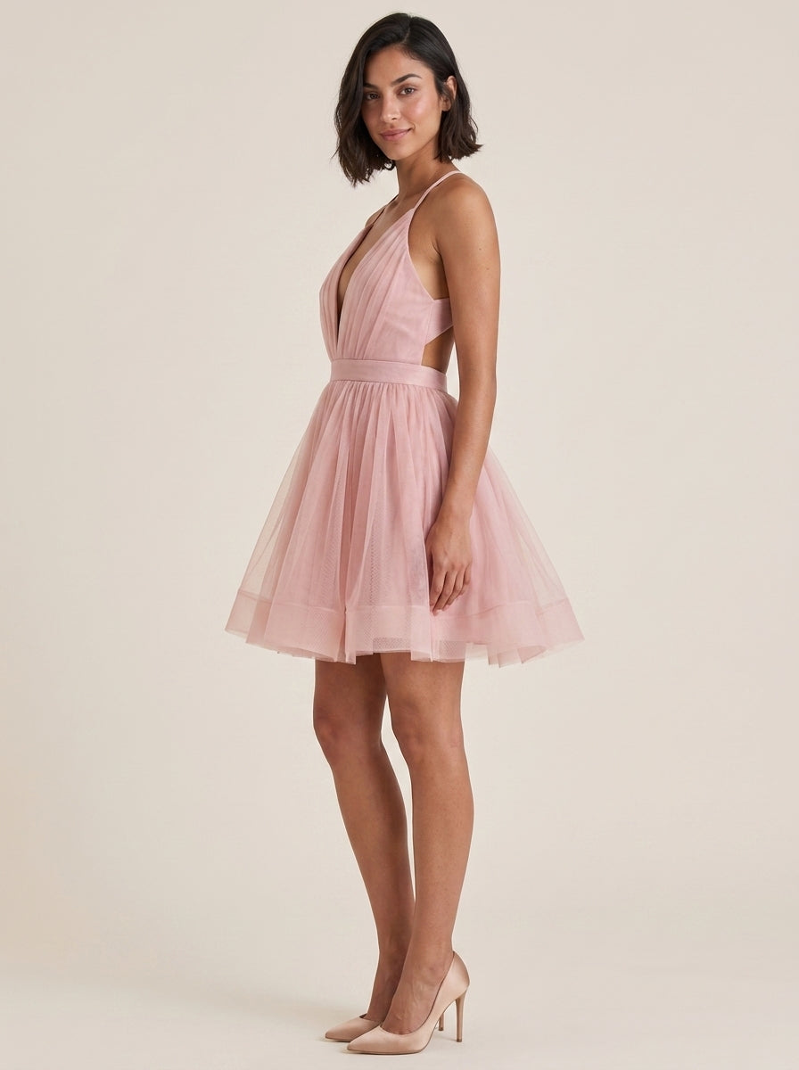 Side profile of the short blush tulle dress, perfect for parties.