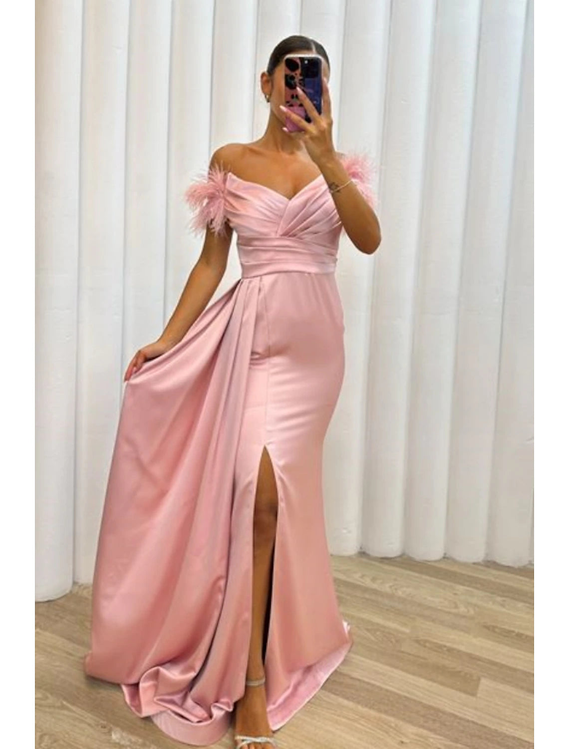 Model walking in the A-line satin gown, highlighting the high slit.