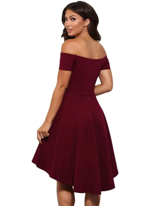 Model posing in a chic off-shoulder stretch satin mini homecoming dress.