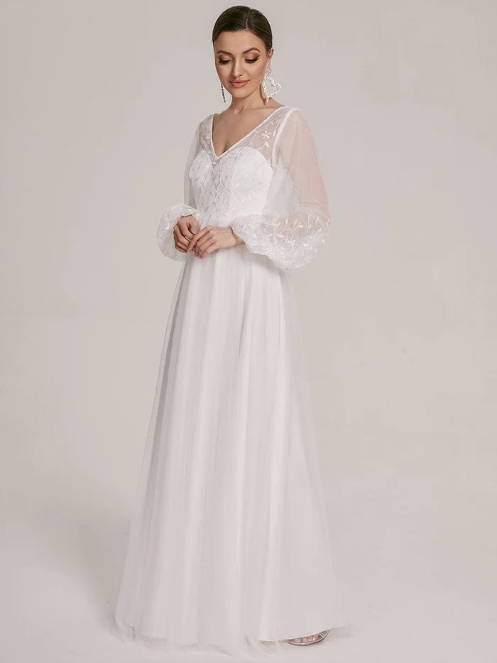Robe de mariée trapèze à manches bouffantes et à fleurs transparentes 