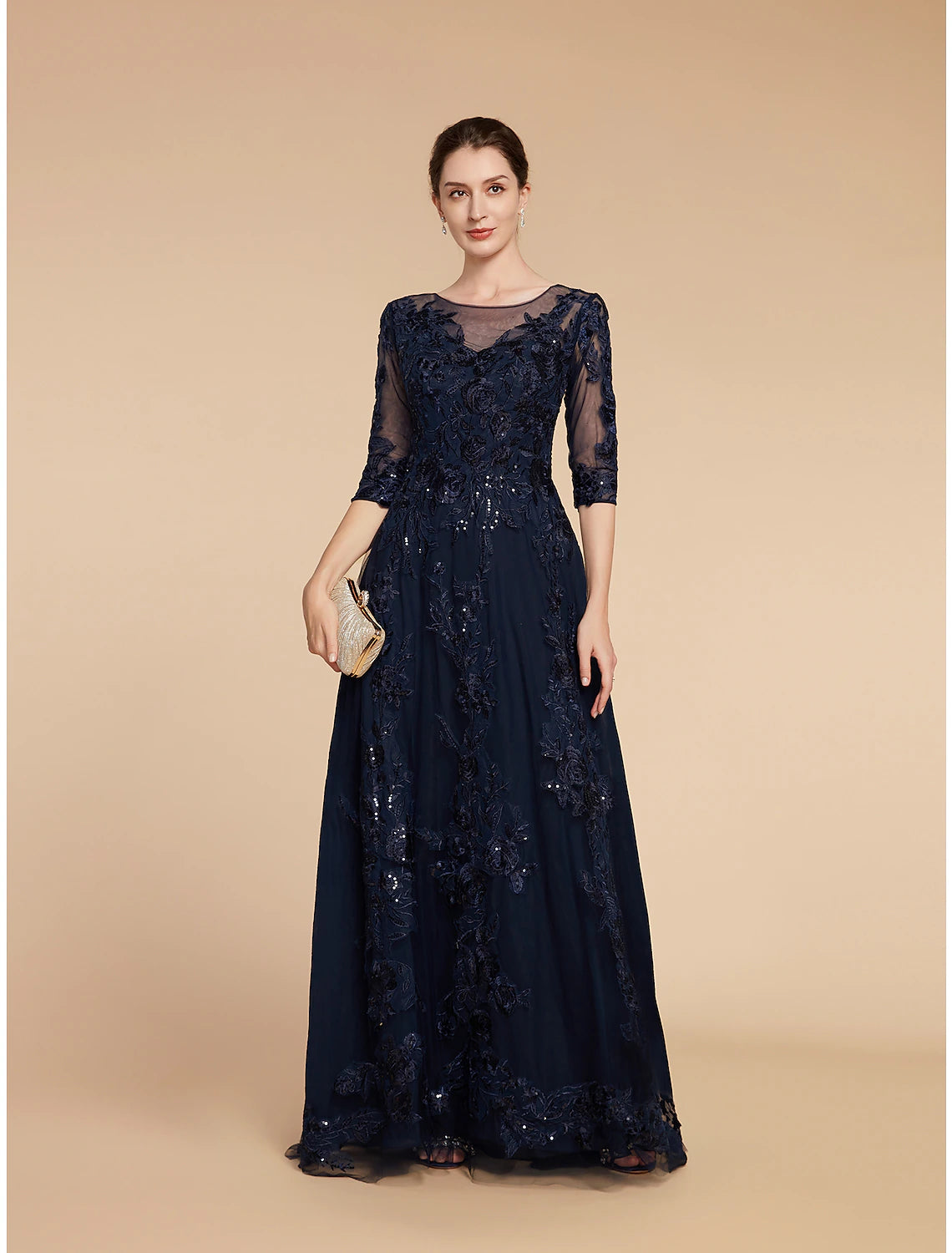Close-up of the scoop neck, 3/4 sleeves, sequin, and chiffon details of the elegant A-line gown.