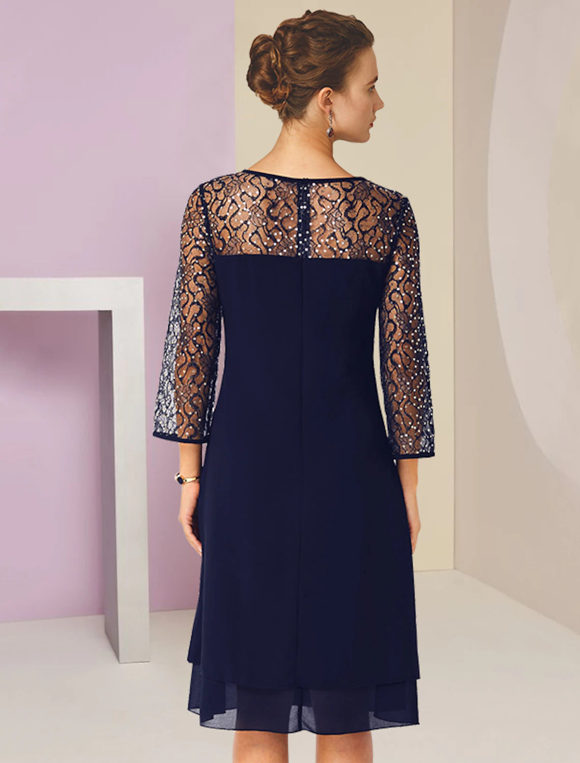 Close-up of the lace and sequin details on the 3/4 sleeve of the A-line formal dress.