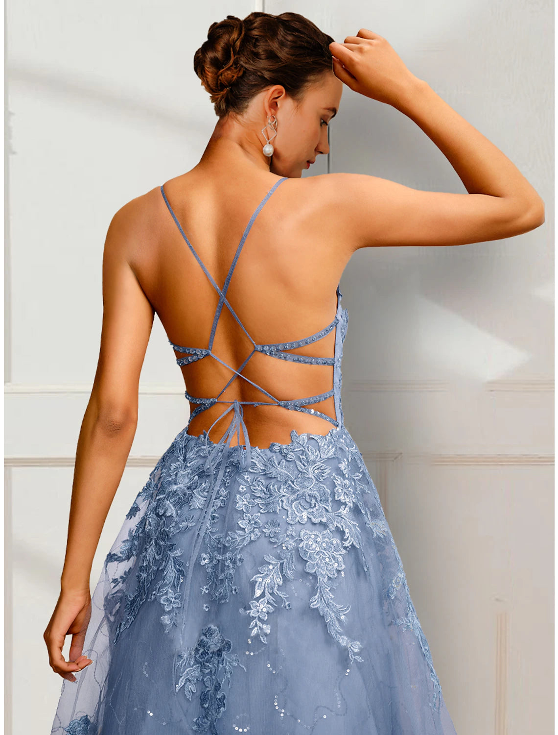 Close-up of floral appliques on satin A-Line prom dress.