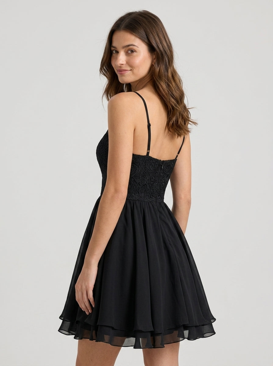 Model wearing elegant A-Line black homecoming dress with above-knee length.