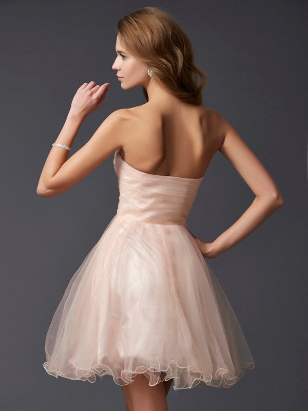 Side view of an elegant A-Line sweetheart short silk-like satin homecoming cocktail dress.