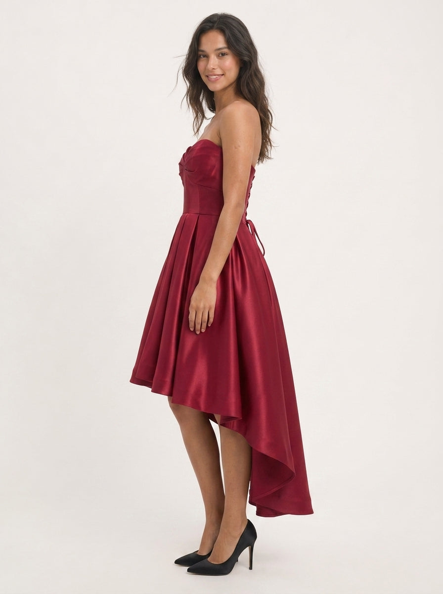 Close-up of the sweetheart strapless neckline on the burgundy dress.