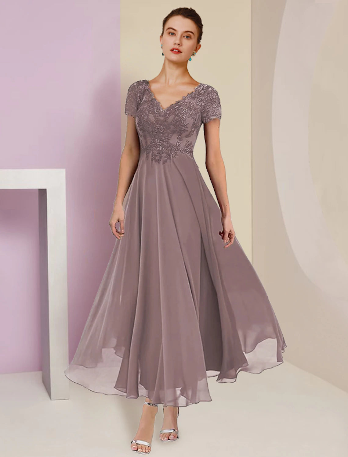 Model wearing elegant A-Line V-Neck Mother of the Bride dress with short sleeves and tea length.