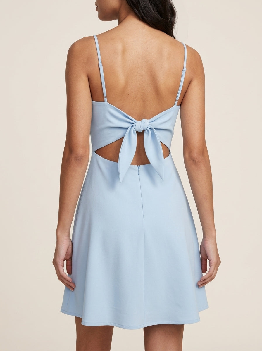 Back view of the light blue A-line homecoming dress, highlighting the open back and bow tie detail.