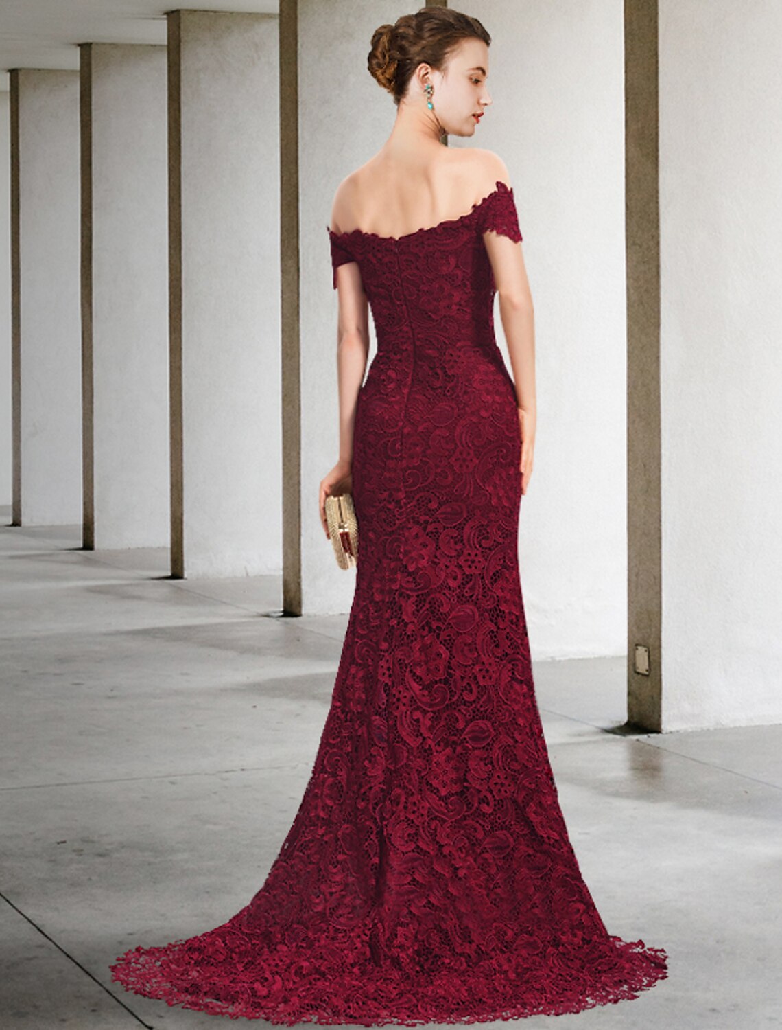 Back view of elegant mermaid trumpet dress, showcasing sweep train and lace details.