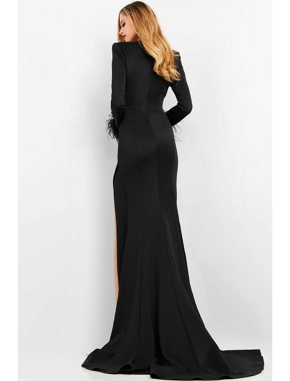 Model posing in a white mermaid V-neck long sleeve formal dress.