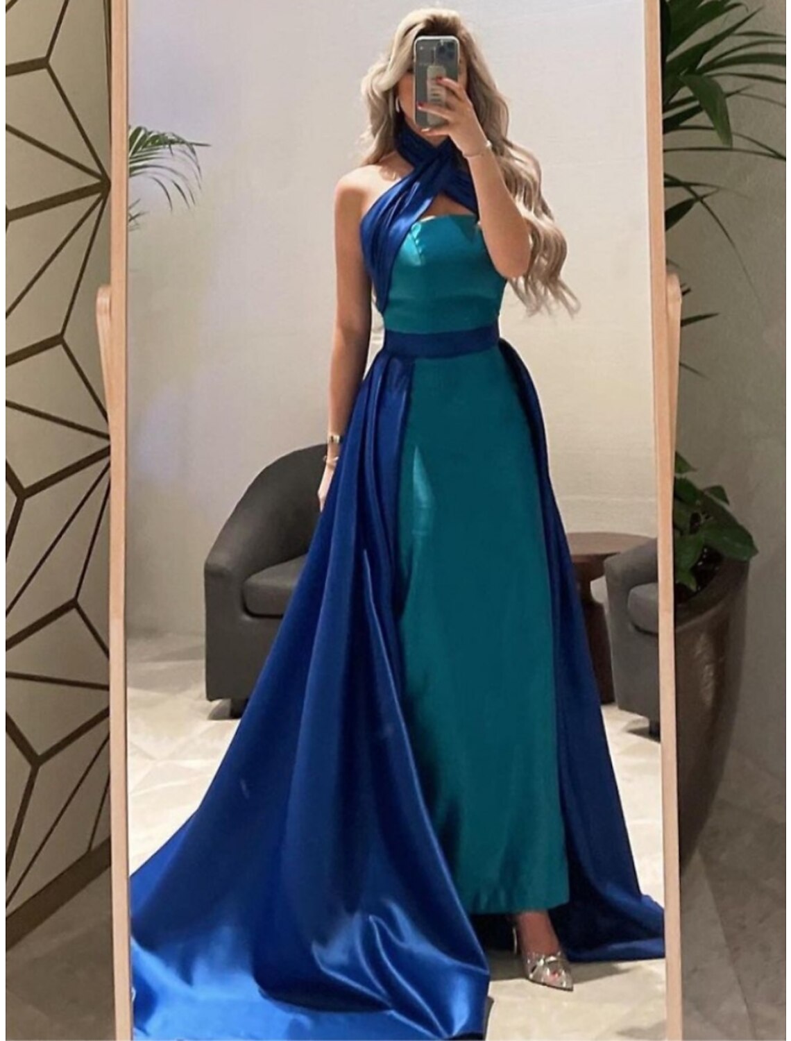 Close-up of the halter neckline and bodice of the elegant navy A-line satin gown.