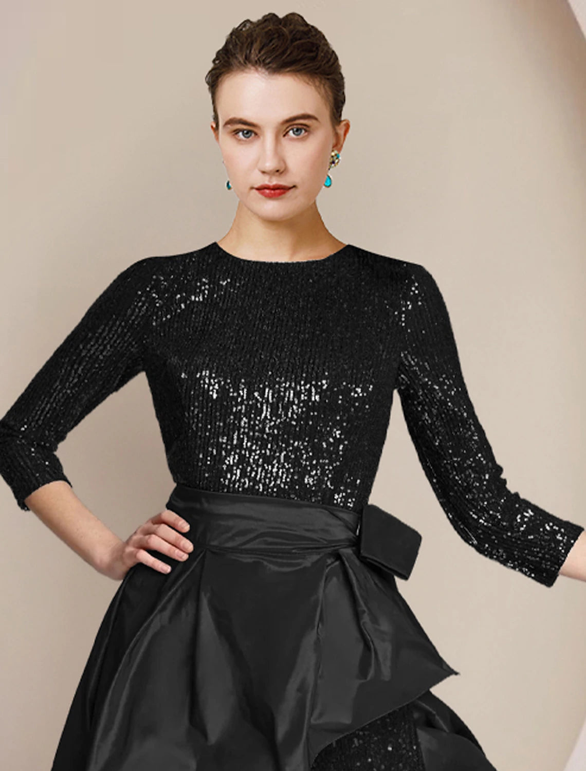 Close-up of the sequined top and scoop neck on the elegant jumpsuit.