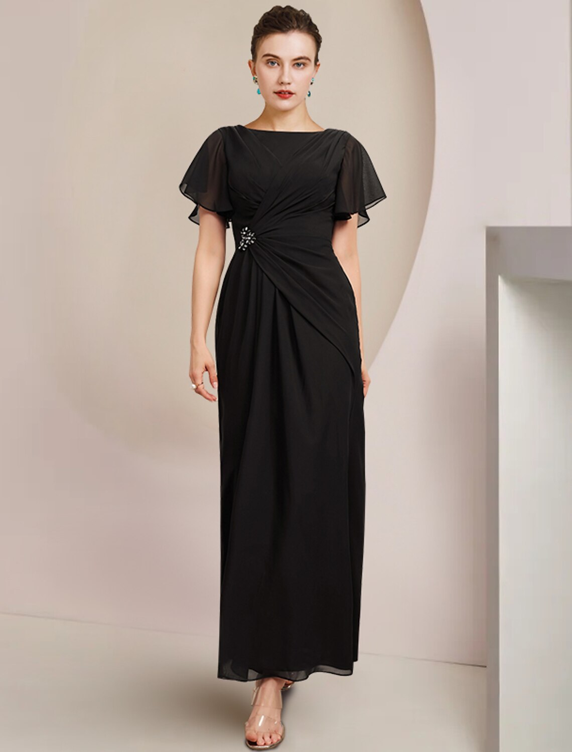 Elegant light blue sheath column Mother of the Bride dress with scoop neck, short sleeves, and crystal brooch detail.