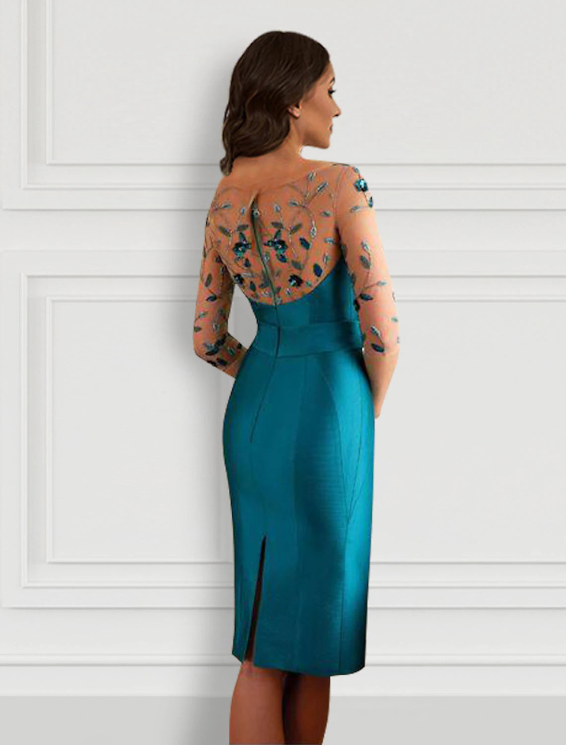 Back view of an elegant sheath jewel neck half sleeve party dress, highlighting the open back and slit detail.