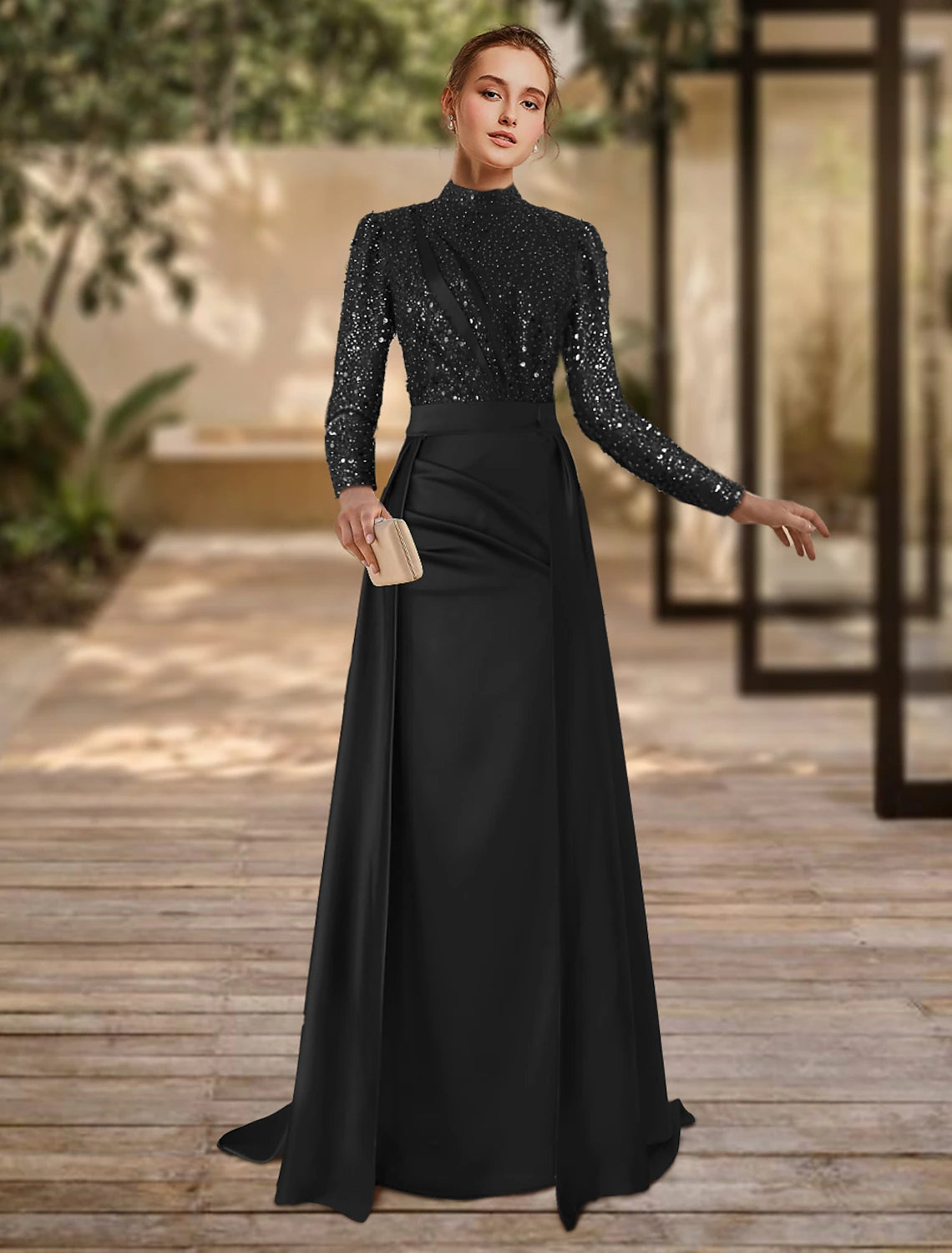Model wearing an elegant red sheath formal gown with long sleeves, jewel neck, and a sweep train.