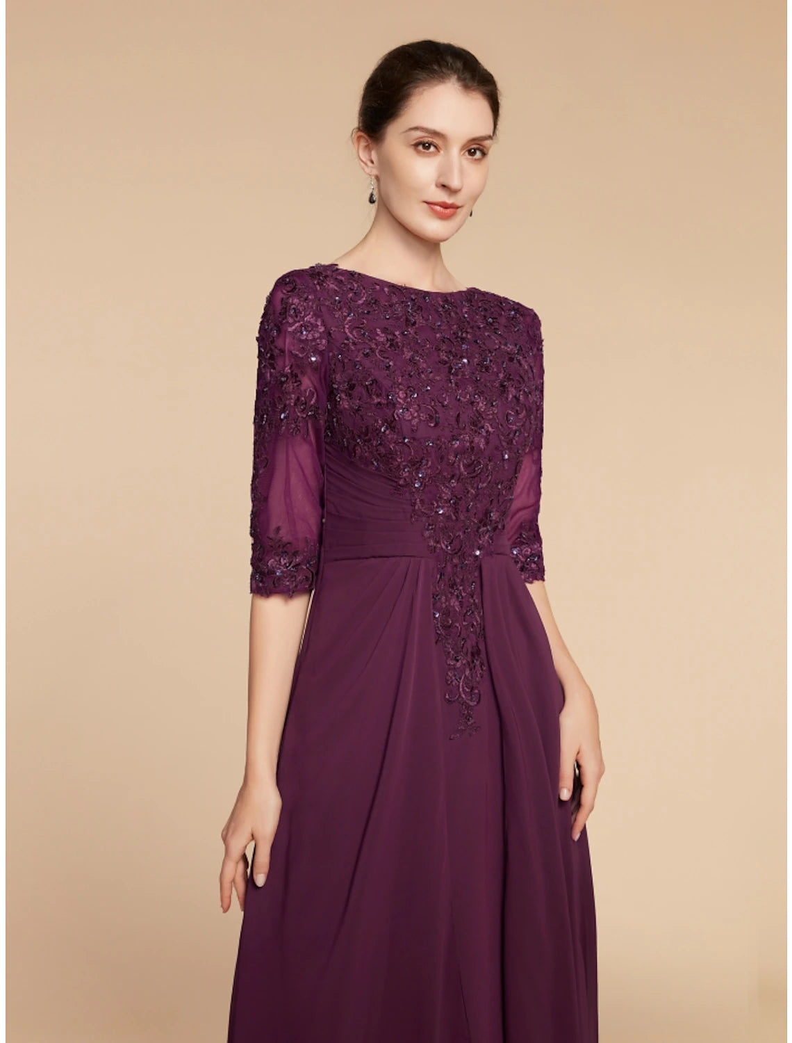 Side profile of the floor-length chiffon and lace wedding guest dress.