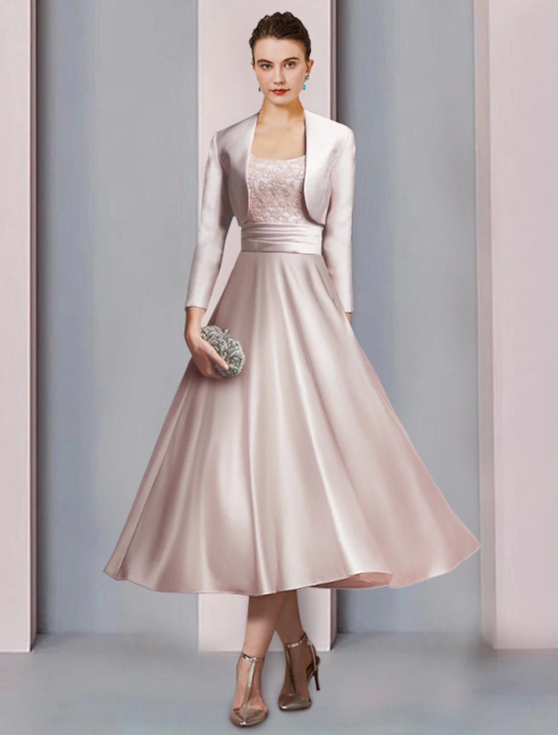 Front view of an elegant two-piece A-line mother of the bride dress with half sleeves and tea length.