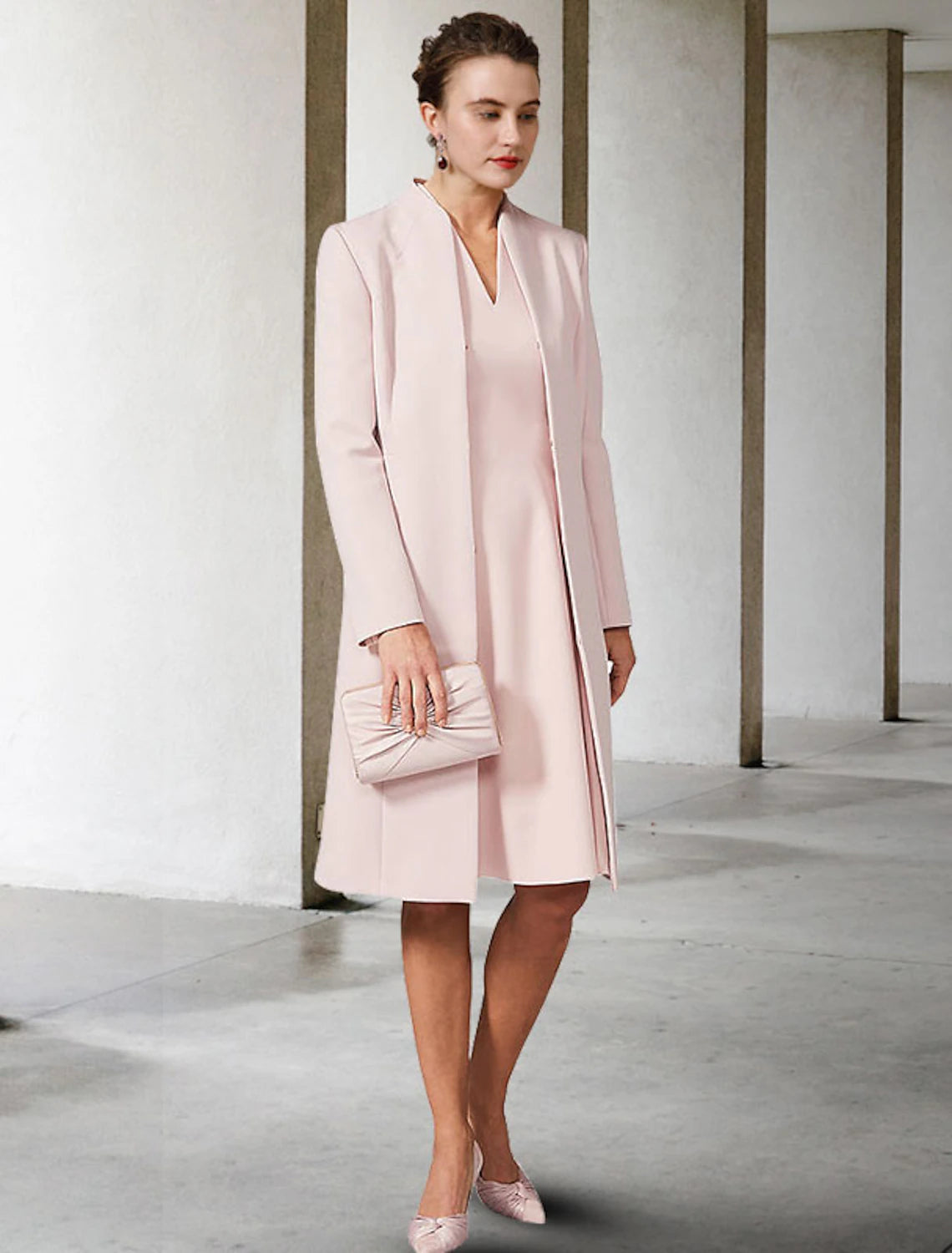 Woman modeling an elegant two-piece A-line V-neck short sleeve chiffon knee-length dress.