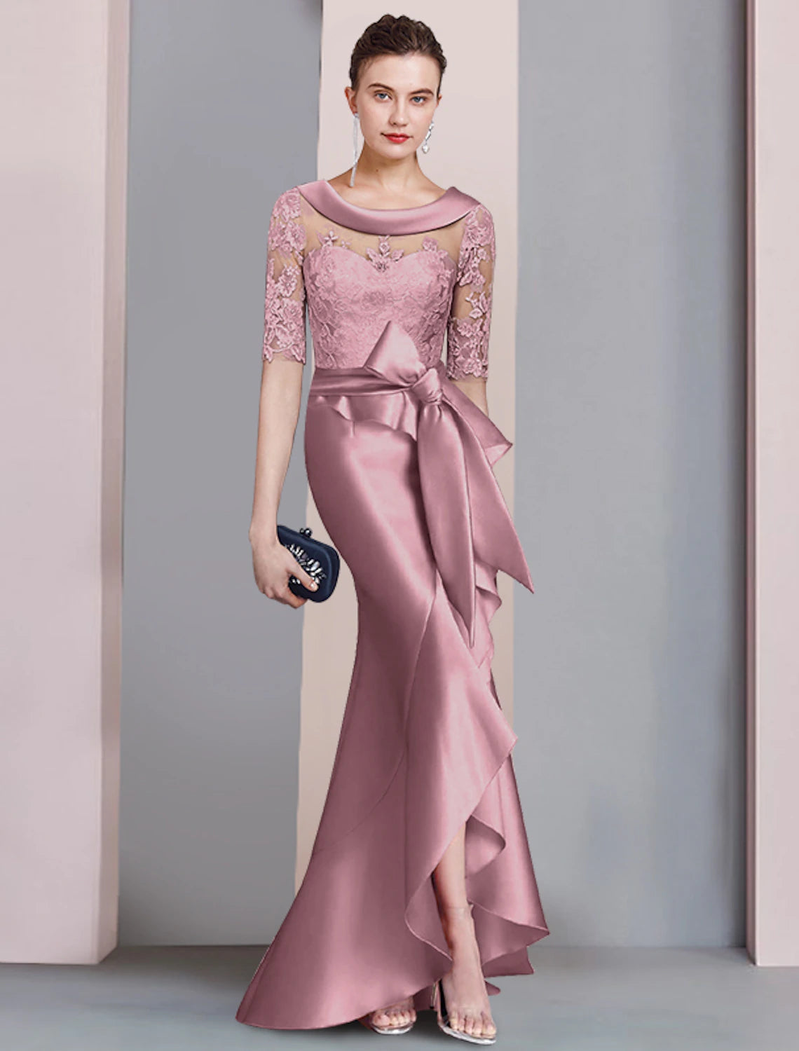 Back view of the formal mermaid trumpet dress, highlighting the asymmetrical design and bow appliques.