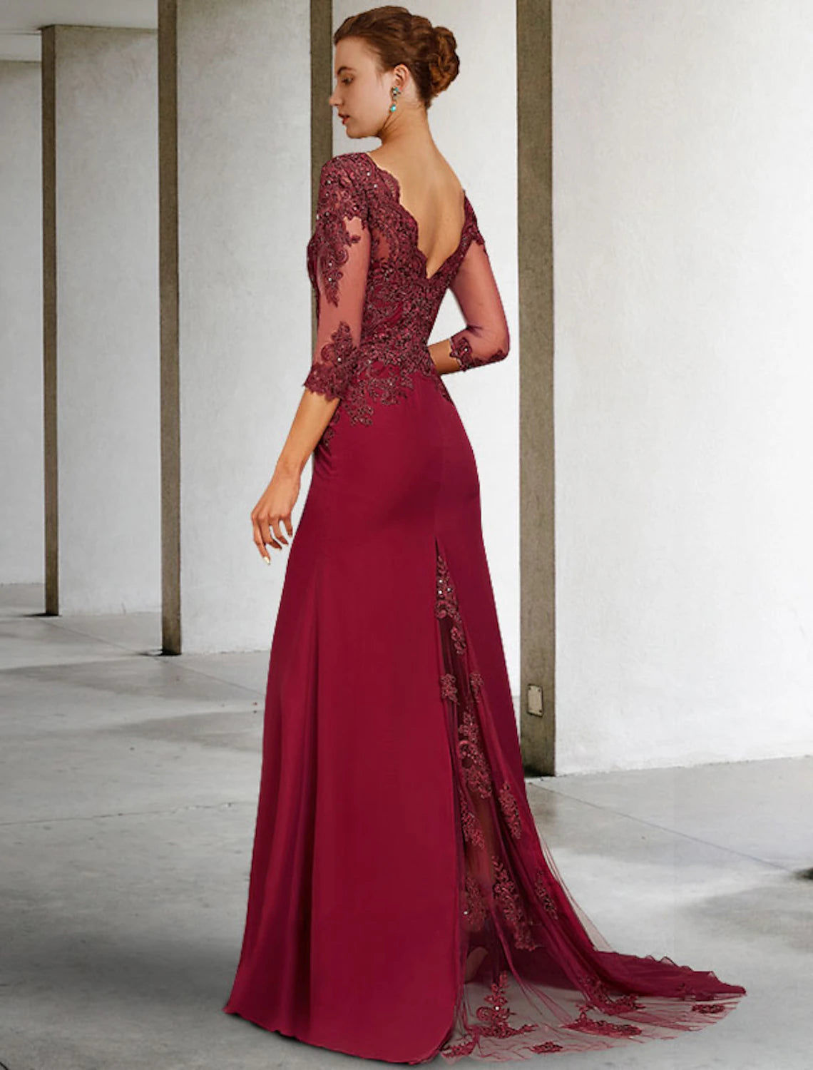 Side view of an elegant mermaid mother of the bride dress, showcasing the 3/4 sleeves and court train.