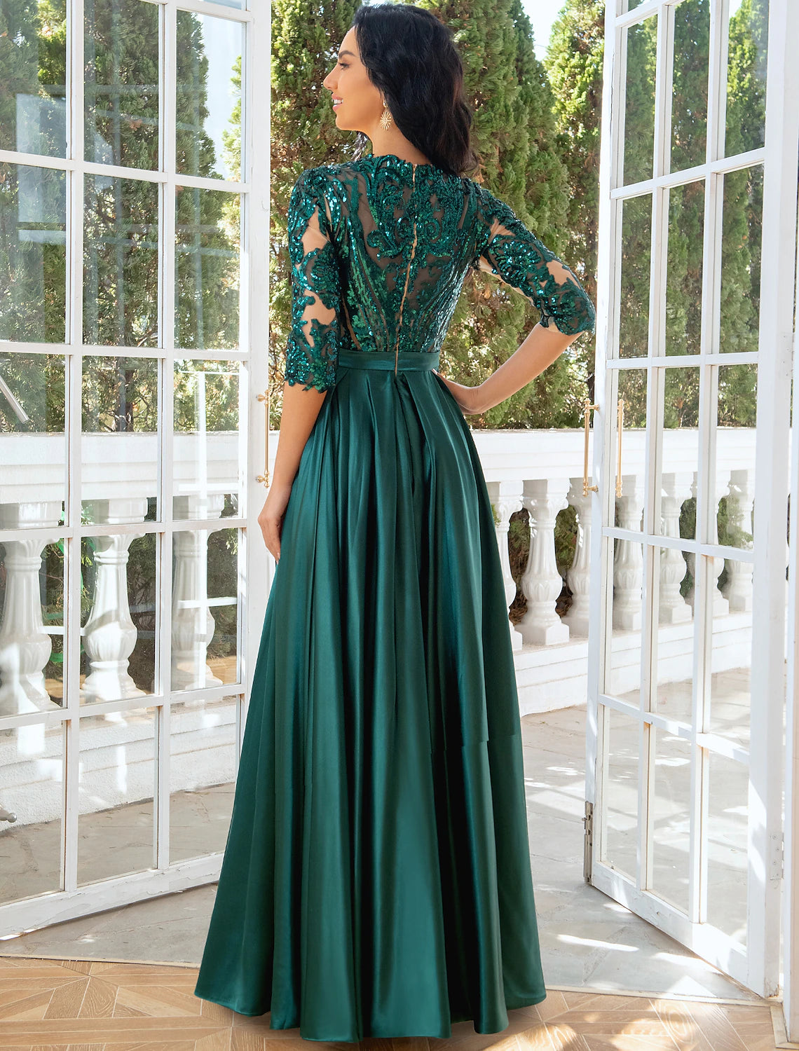 Back view of the A-line evening gown, showing elegant pleats.