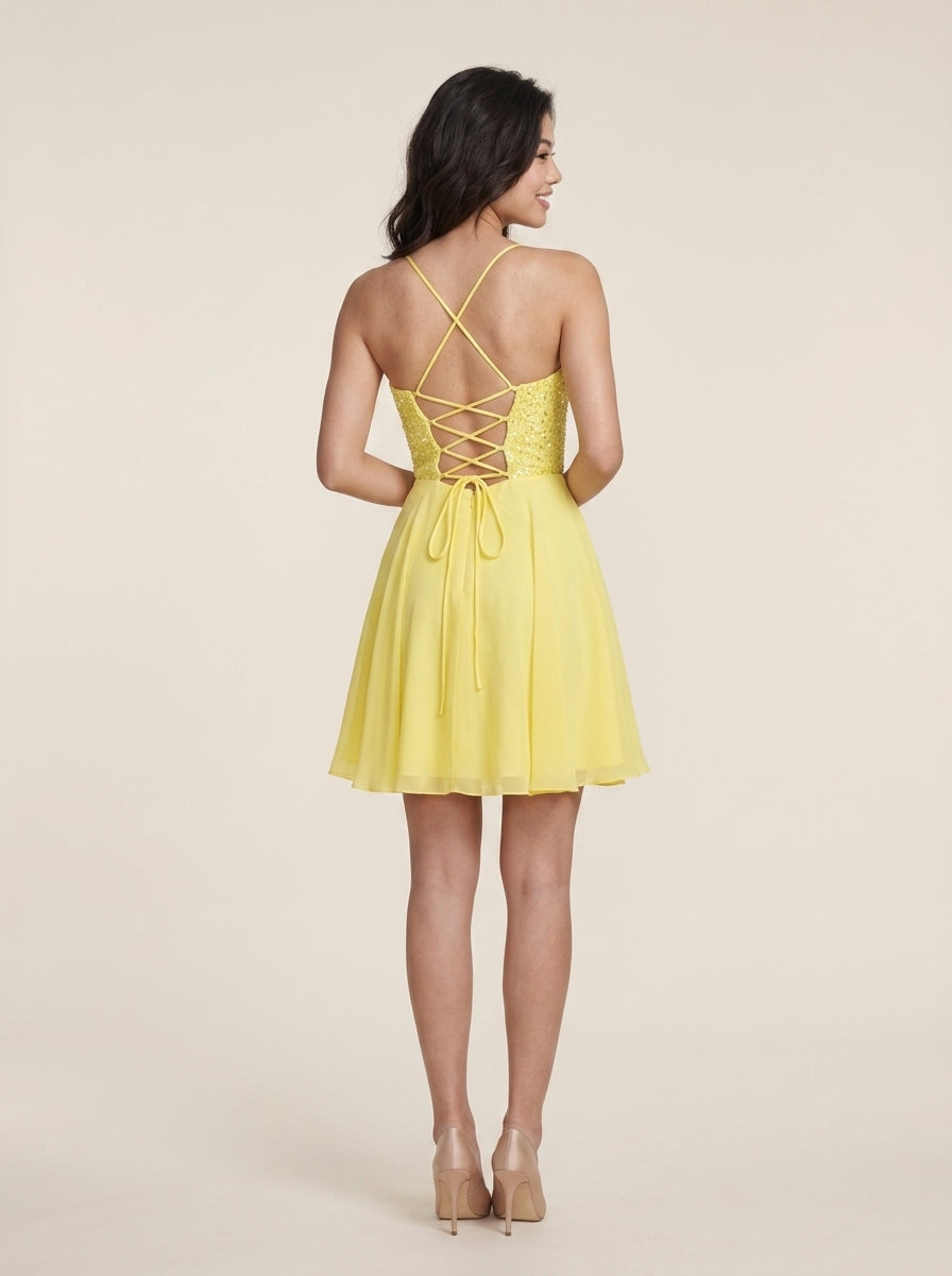 Back view of yellow A-Line homecoming dress with criss-cross lace-up detail.