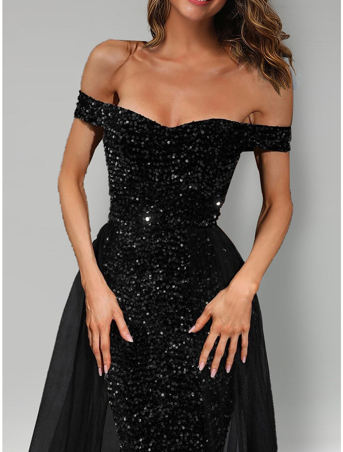 Close-up of the sequin-embellished tulle fabric on the black mermaid evening gown.