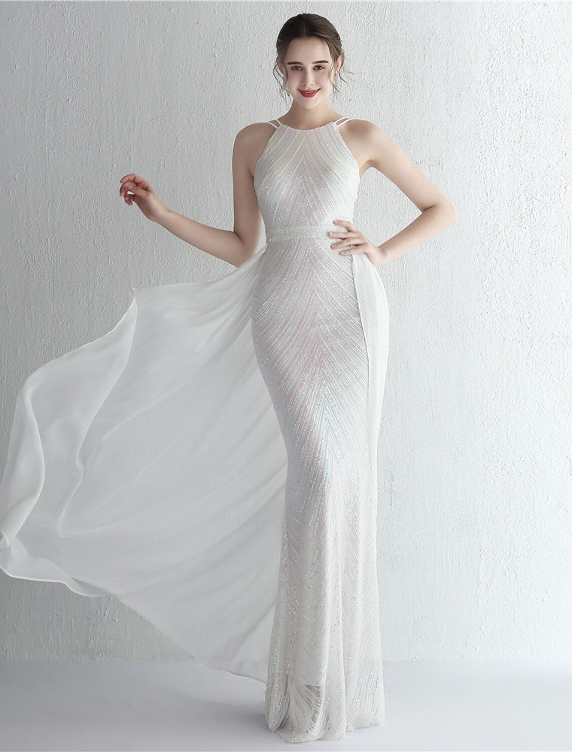 Woman in a sparkling mermaid halter neck prom dress.