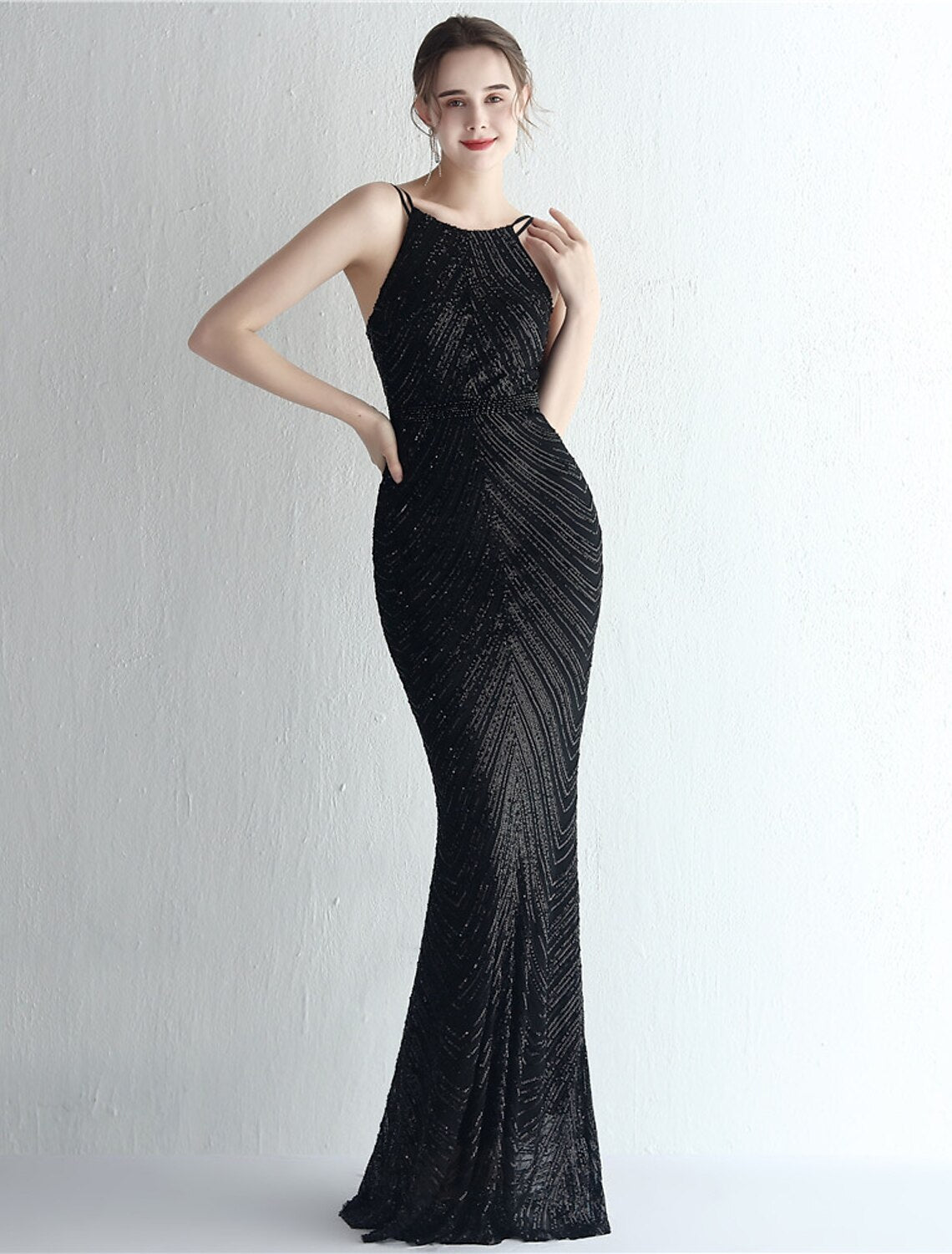 Close-up of sequin and beading detail on a halter neck formal dress.