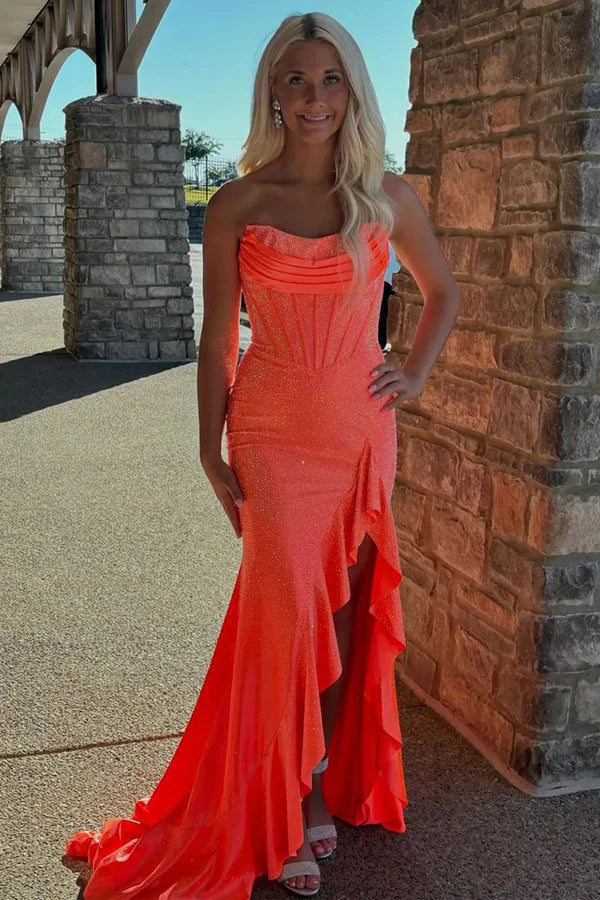 Vibrant strapless glitter prom gown with ruched bodice, lace-up back, ruffle trim and mermaid train