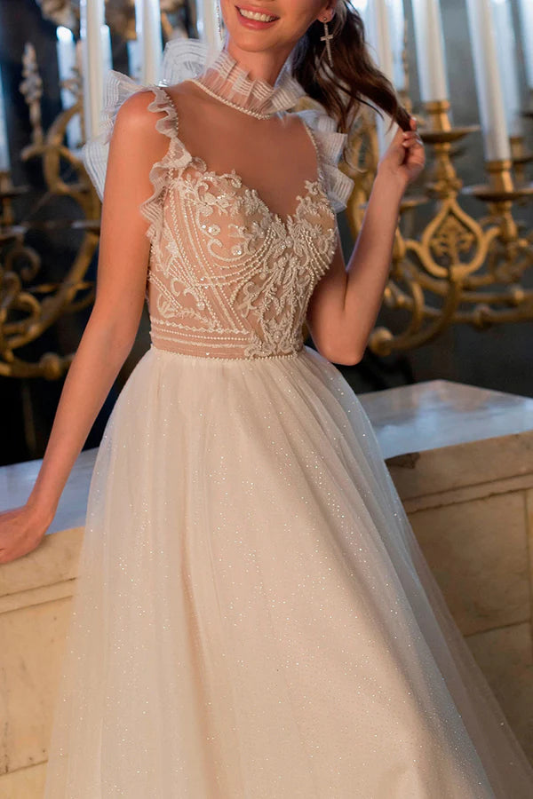 Une robe de mariée bohème avec une illusion de fil et des perles scintillantes à l'encolure