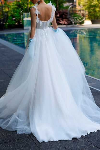 A simple wedding dress with thin shoulder straps, spoonful beads and a single thread